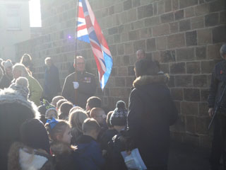 Photo 13  - 2016 Normanby Remembrance Day - 
The Sun Shines Brightly upon the Union Flag Held Aloft by Andrew Forde